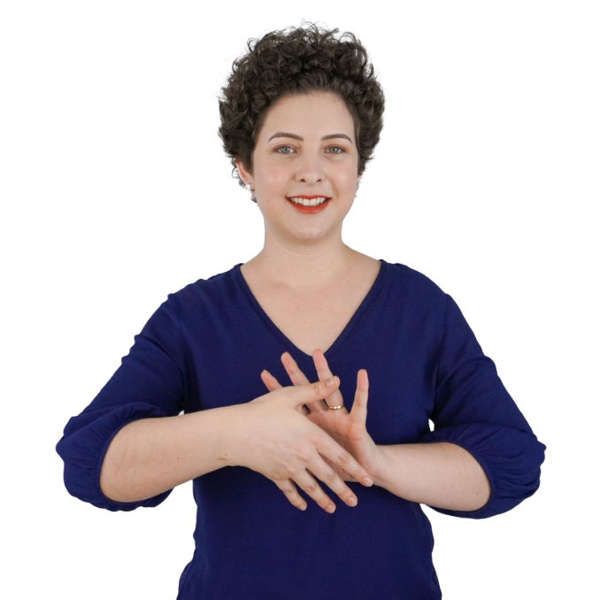 Foto de Paloma Bueno, uma mulher jovem, de cabelos curtos cacheados e volumosos. Ela veste uma blusa azul, usa um batom avermelhado, brincos pequenos, faz um sinal em Libras com as mãos e sorri.